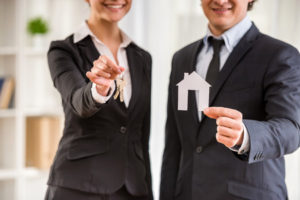 realtors handing keys to new owners